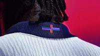 The multicoloured cross on the collar of the new England kit.