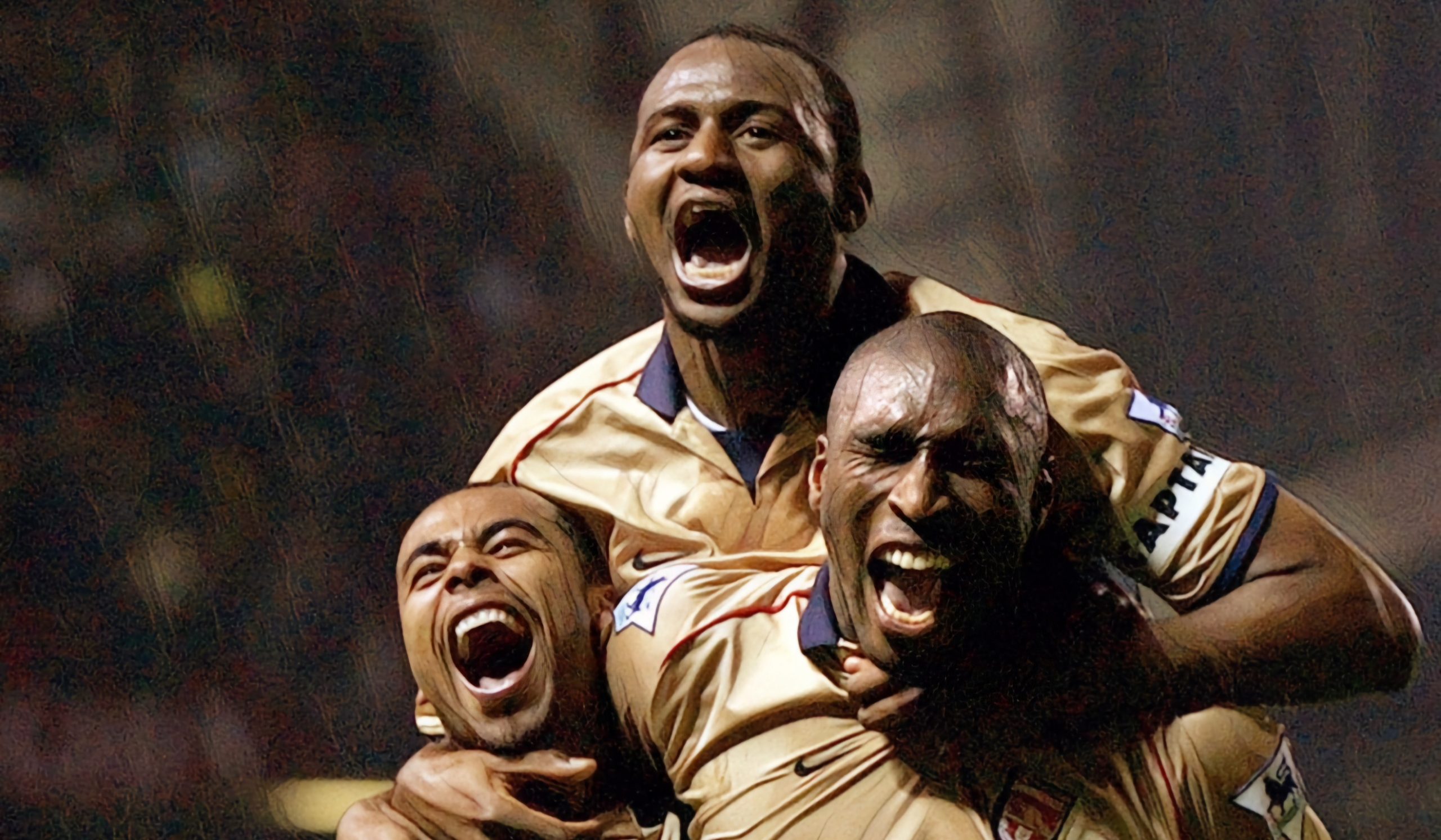 Arsenal players Ashley Cole, Patrick Vieira and Sol Campbell celebrate during the Premier League match between Manchester United and Arsenal played at Old Trafford, in Manchester, England on May 8, 2002. Arsenal won the match 1-0 to clinch the league title.