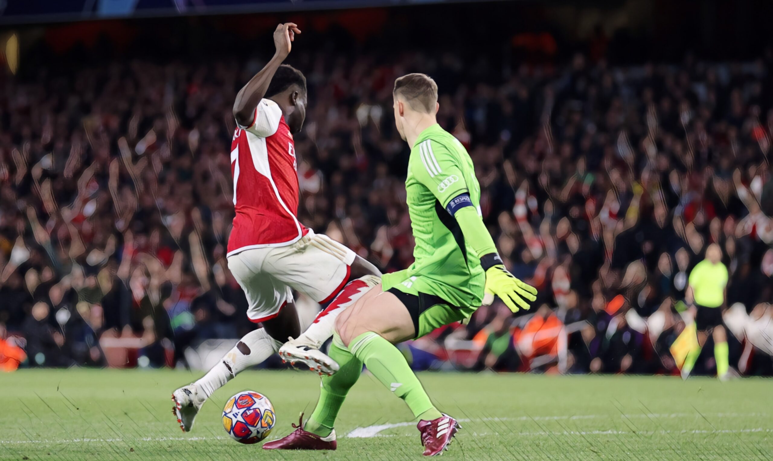 Bukayo Saka of Arsenal collides with Manuel Neuer of Bayern Munich towards the end of the UEFA Champions League quarter-final first leg match between Arsenal FC and FC Bayern Munchen at Emirates Stadium on April 9, 2024 in London, England