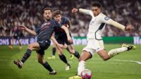 Jude Bellingham of Real Madrid CF and Bernardo Silva of Manchester City battle for the ball during the UEFA Champions League quarter-final first leg match between Real Madrid CF and Manchester City at Estadio Santiago Bernabeu on April 9, 2024 in Madrid, Spain