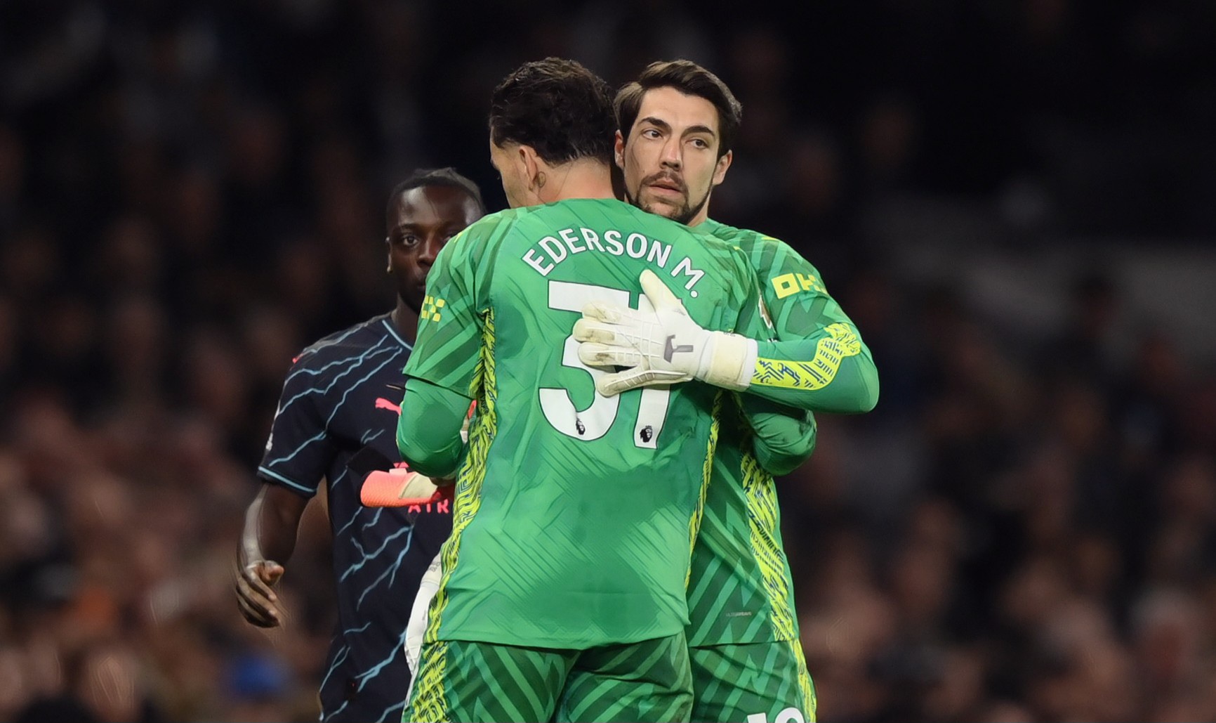 Stefan Ortega of Manchester City embraces teammate Ederson as he is substituted during the Premier League match between Tottenham Hotspur and Man City at Tottenham Hotspur Stadium on May 14, 2024