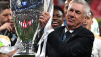 Real Madrid's Italian coach Carlo Ancelotti lifts the trophy to celebrate the victory at the end of the UEFA Champions League final football match between Borussia Dortmund and Real Madrid, at Wembley stadium, in London, on June 1, 2024.