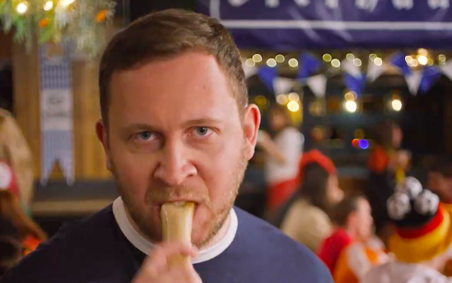 A Scotland fan bites down on a hot dog during IRN BRU's football ad ahead of Euro 2024.