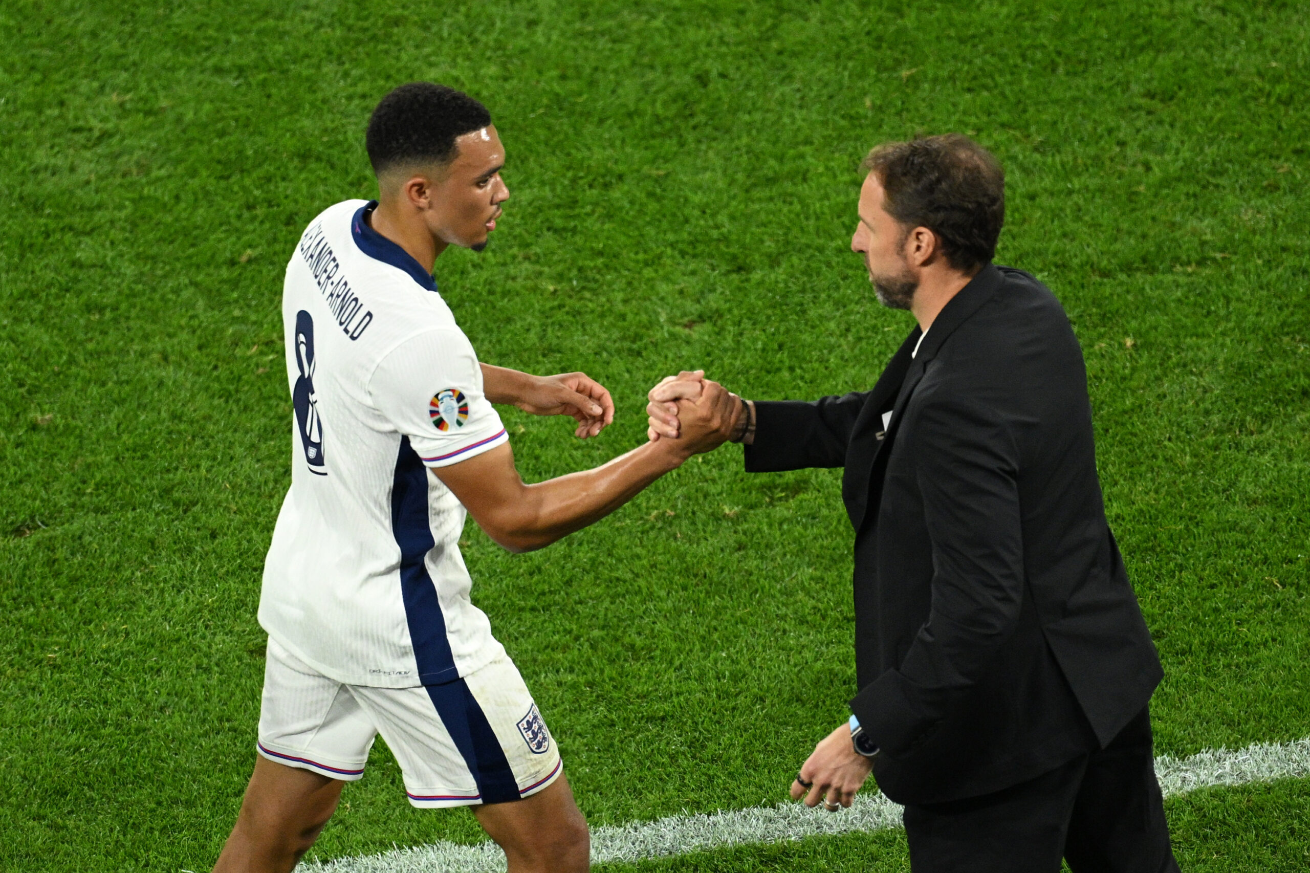 Trent Alexander-Arnold of Liverpool shakes hands with England manager Gareth Southgate, as he comes off after being substituted during the UEFA EURO 2024 group stage match between Serbia and England at Arena AufSchalke on June 16, 2024 in Gelsenkirchen, Germany.