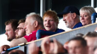 British singer Ed Sheeran (C) attends the English Premier League football match between Ipswich Town and Liverpool at Portman Road in Ipswich, eastern England on August 17, 2024.