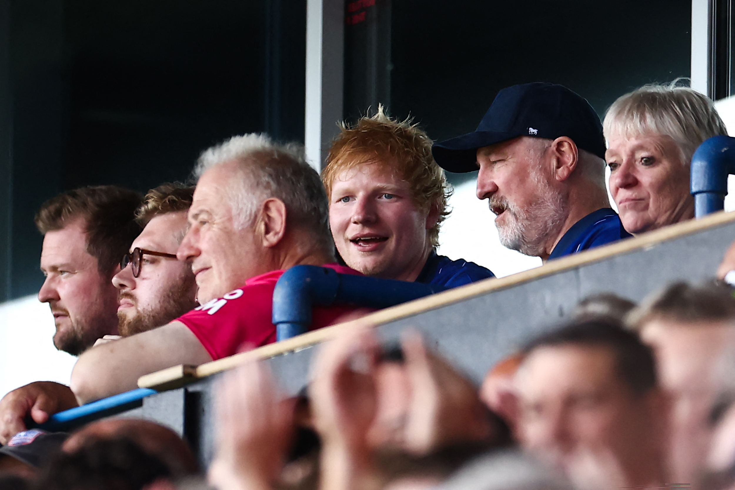 British singer Ed Sheeran (C) attends the English Premier League football match between Ipswich Town and Liverpool at Portman Road in Ipswich, eastern England on August 17, 2024.